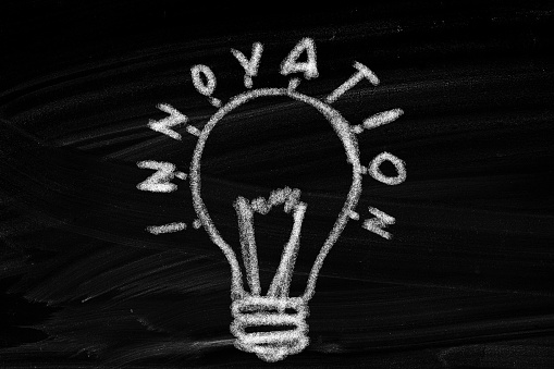 lightbulb painted black marker closeup on a white board