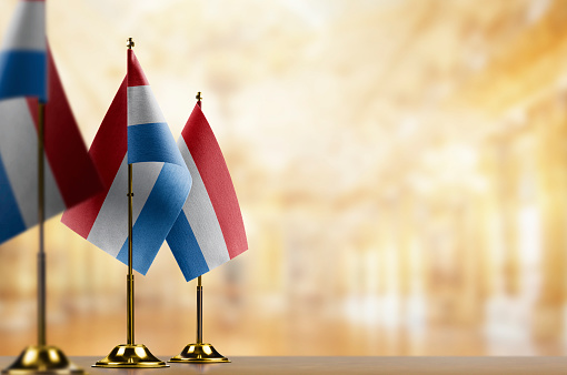 A small Netherlands flag on an abstract blurry background.