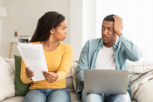 istock Angry sad young african american female with documents scolds at guy with laptop due mistake 1478730372