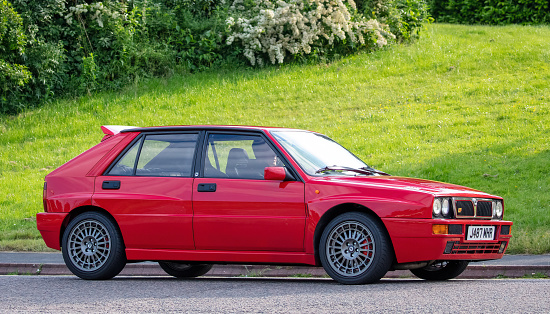 Milton Keynes, Bucks, UK - June 3rd 2022. 1991 red Lancia Delta travelling on an English road