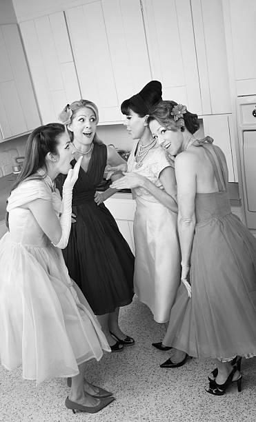 istock Four women in formal dresses gossiping in kitchen 147873178