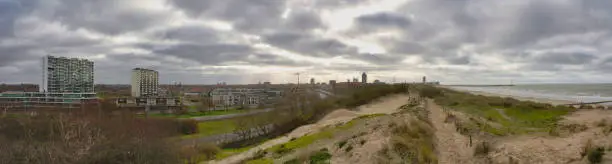 Photo of Panorama of Ostend beach, dunes and inland city view in Belgium under clouded sky
