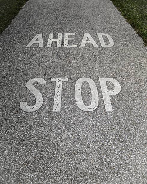 istock Vertical closeup of paint on a concrete path writing 