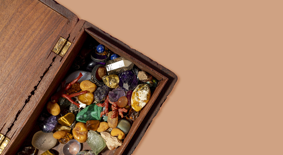 A top view of colorful stones in a wooden box