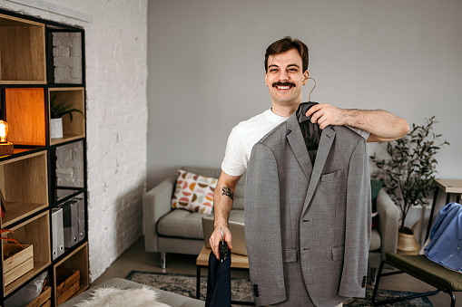 Man chooses business clothes for a trip