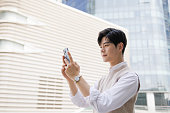 businessman use mobile phones to receive information outdoors