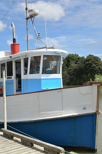 Auckland, New Zealand – January 17, 2021: View of Manukau Charters Ratahi motor boat in Waiuku River