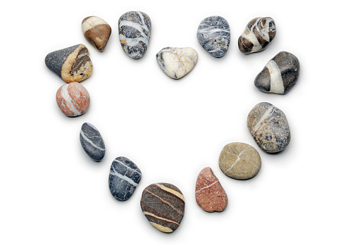 Heart shape pebbles frame isolated on white background