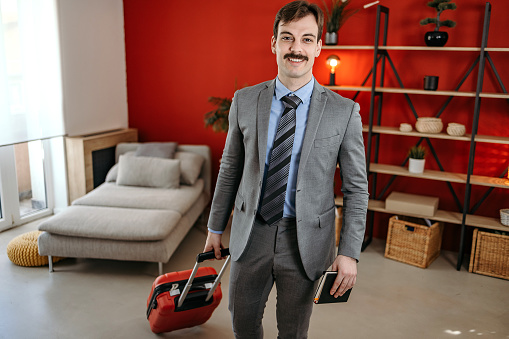 Business man in a suit with a suitcase