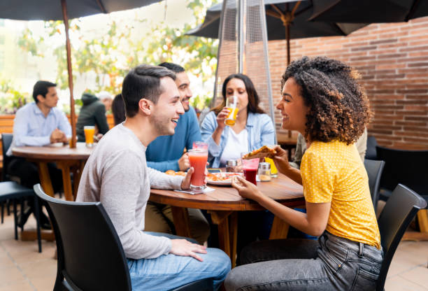 istock Friends looking very happy eating pizza at a restaurant 1478742901