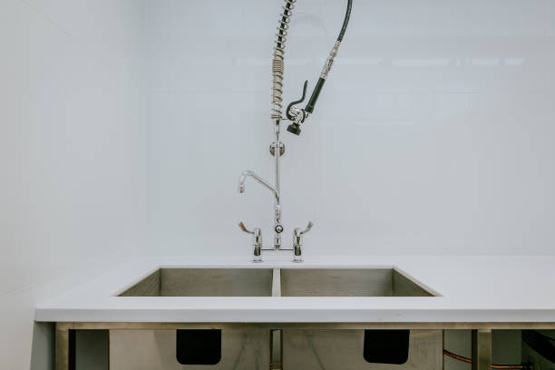 istock New kitchen sink with a long water hose on a white wa 1478743407