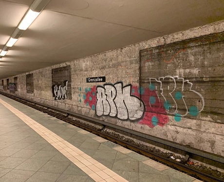 Berlin, Germany – July 08, 2019: A subway station in Berlin, Germany with the wall beside the rails covered in graffiti spray paint