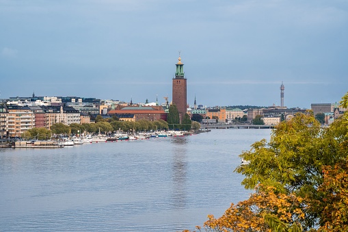 The blue sky over Stockholm City Hall and port on the other side of the river