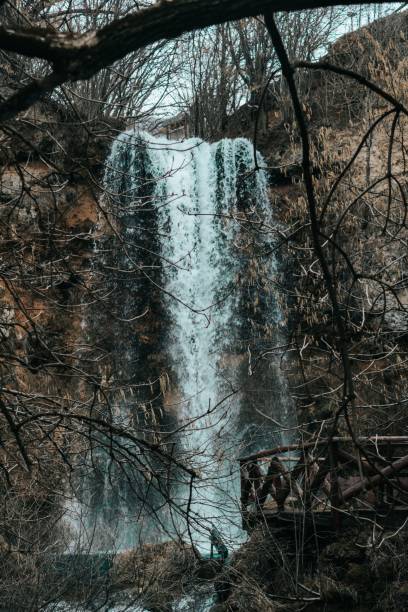 istock Vertical shot of a beautiful waterfall flowing in the forest 1478744007