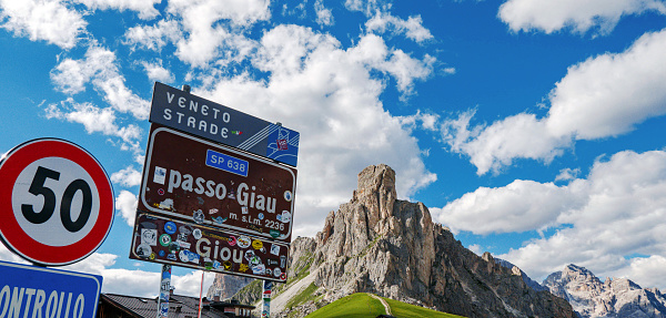 Cortina d'Ampezzo, Italy – January 20, 2021: Sign post on mountain pass road in Italian Dolomites. Passo Giau, mountains, nature, outdoors, travel.