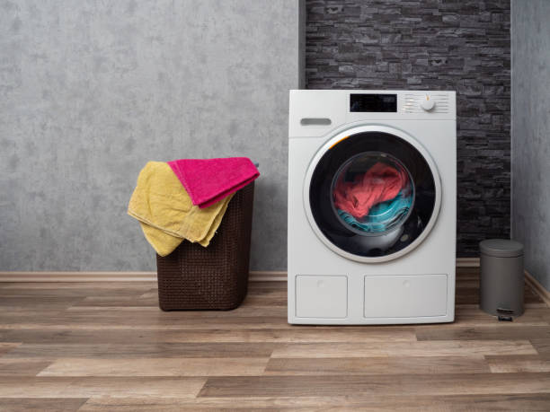 istock Laundry room interior with washing machine against the wall. 1478745059