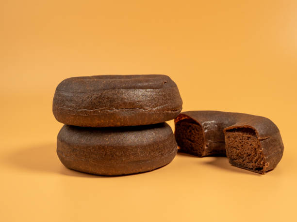 istock Fresh dark vegetarian donut on orange background. 1478746933