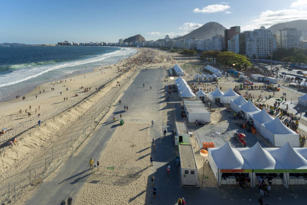 Beach of Copacabana during summer games Rio de Janeiro, Brazil – August 13, 2016: Tents of the entrance to the Olympic Volleyball stadium on the beach of Copacabana seen from high up in the stadium itself beach volleyball olympics stock pictures, royalty-free photos & images
