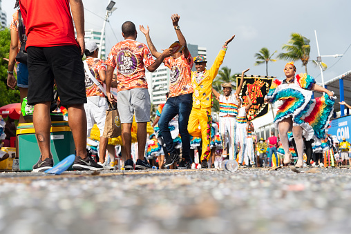 Salvador, Bahia, Brazil - February 11, 2023: People dance, jump and play in the street during the pre-Carnival Fuzue parade in the city of Salvador, Bahia.