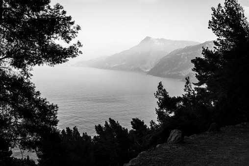 A grayscale shot of The Mediterranean sea and mountains in Mallorca, Spain