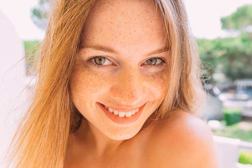 portrait of woman with freckles and a beautiful smile
