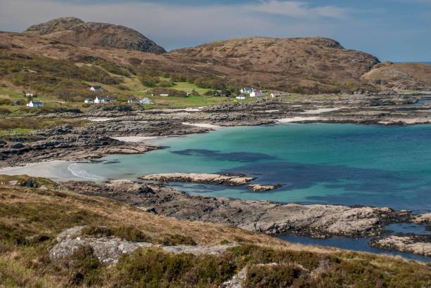 Beautiful sandy beaches in Achmelvich Bay surrounded by rugged countryside in the Scottish Highlands.