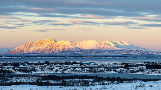 An aerial shot of a scenic mountain under a colorful sunset in Reykjavik, Island
