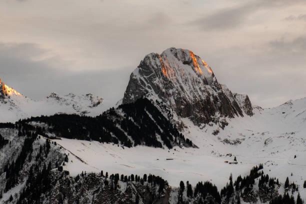istock Snowy mountain landscape against the bright cloudy sky 1478756442