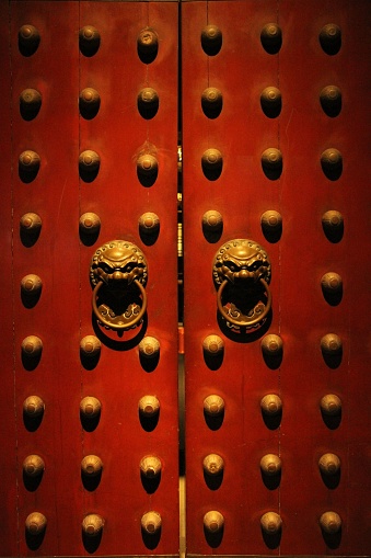 Chinatown, Singapore – November 27, 2022: A vertical shot of a red wooden door of a temple at Chinatown, Singapore