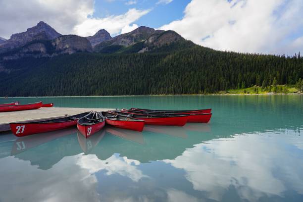 istock Red canoes on Lake Louise in front of a mountain range 1478757593