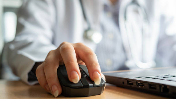 istock Close-up Female doctor using wireless mouse in office 1478759785
