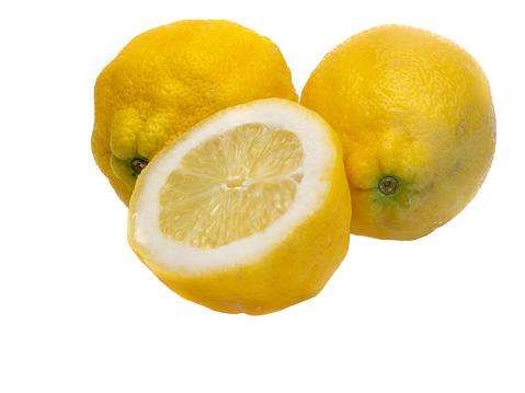 Two and a half lemons isolated on white background from above. Selective focus