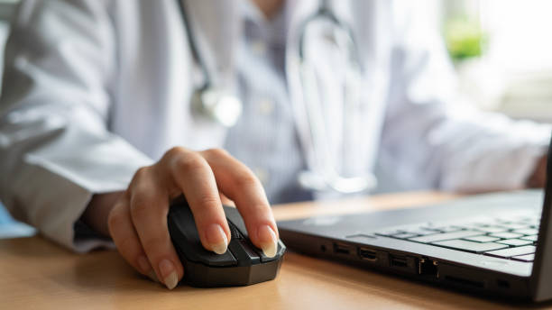 istock Close-up Female doctor using wireless mouse in office 1478759931