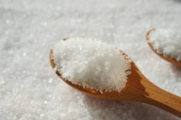 istock Spoon of coarse salt with coarse salt background 1478760811