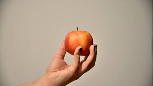 istock Woman holding an red apple 1478762122