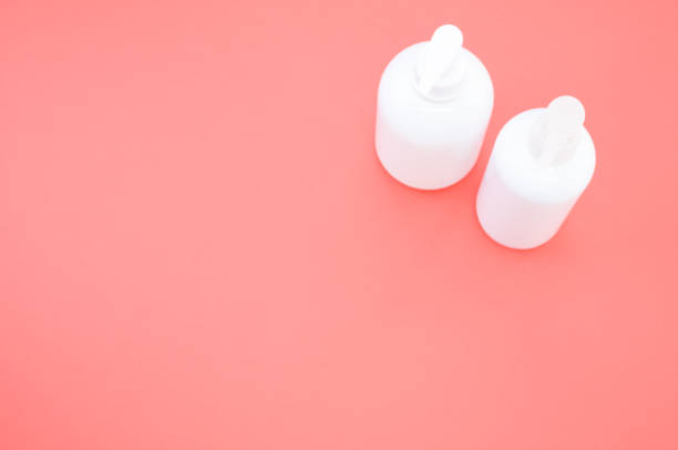 istock Top view of plastic bottles with pumps on a red surface under the lights 1478763666