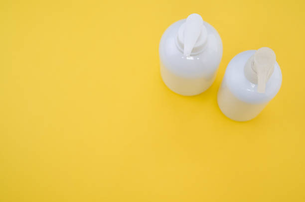 istock High angle shot of plastic bottles with pumps on a yellow surface under the lights 1478763695