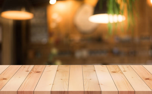istock Empty wooden table top with lights bokeh on blur restaurant background. 1478765668