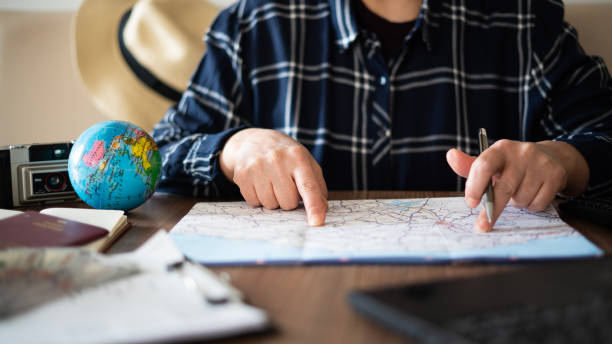 istock Close-up Woman planning vacation with world map 1478767556