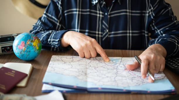 istock Close-up Woman planning vacation with world map 1478767569