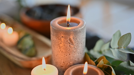 Background of aromatherapy candles, spa and for zen wellness, self care experience or relax in peace. Closeup of flame in beauty salon in calm space, holistic service and stress relief in hospitality