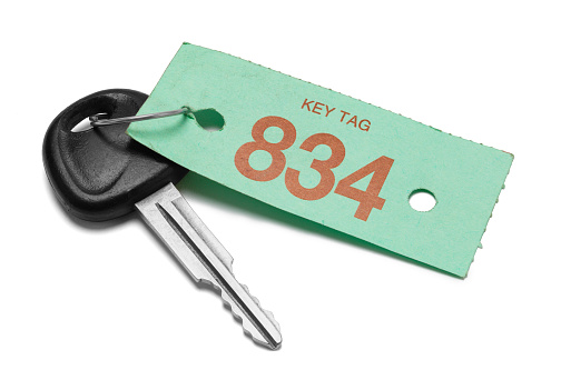Car key With Green Service Tag Cut Out on White.