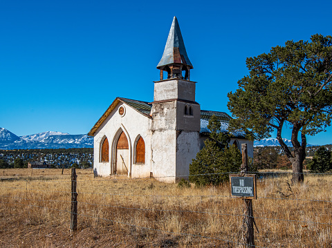 An old abandoned and neglected church still stands tall in the rural Colorado countryside of the Wet Mountain Valley.