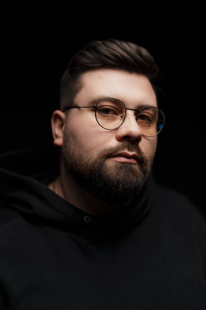 istock Confident bearded man in eyeglasses on black background 1478774403