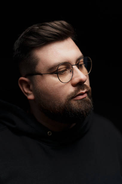 istock Confident bearded man in eyeglasses on black background 1478774413