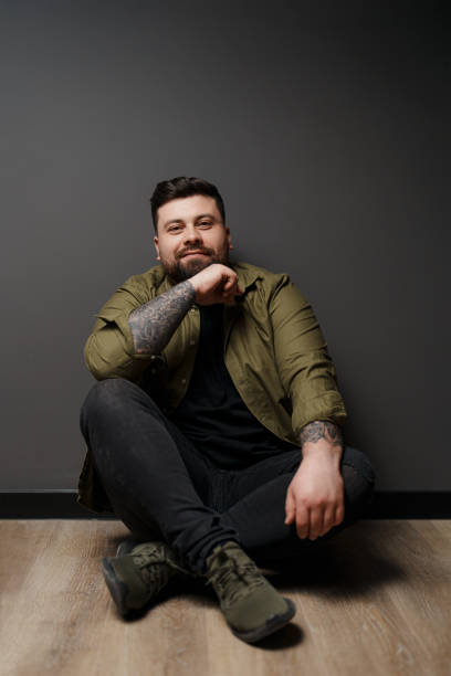 istock Content man sitting on floor with crossed legs 1478774520