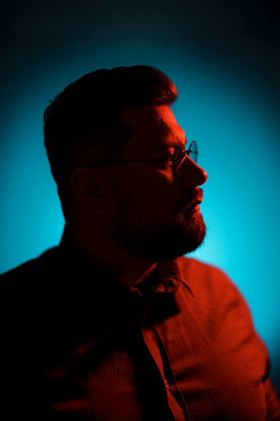 istock Serious man in eyeglasses looking at camera in neon light 1478774544