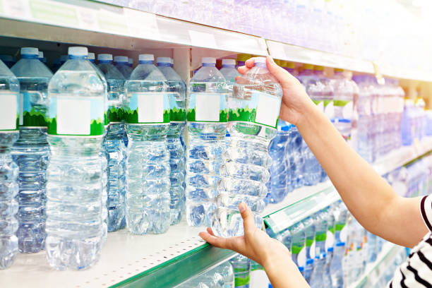 istock Hand with bottles of water in store 1478776644