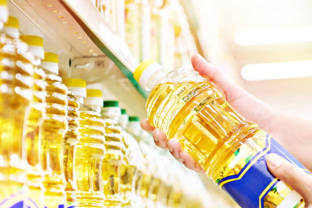 istock Sunflower oil in hands at store 1478776664