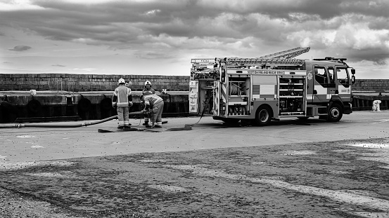 Scottish Fire And Rescue at work at Burghead Harbour, Monochrome image